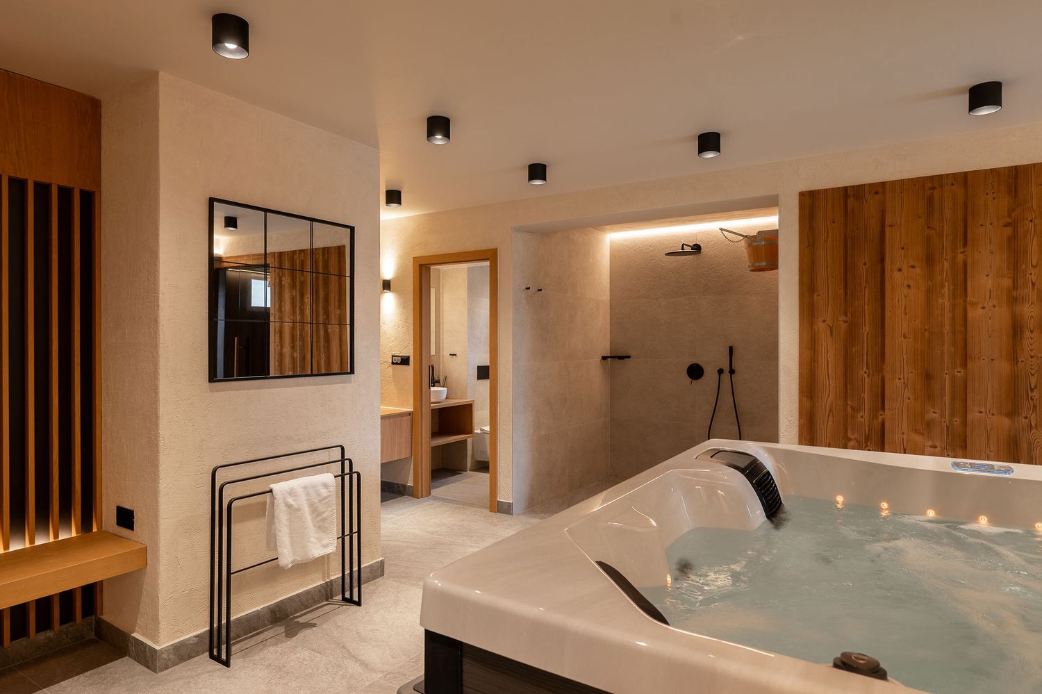 Private indoor jacuzzi suite with candlelight and dark wood paneling